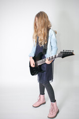 Young girl with electric guitar on smoky background