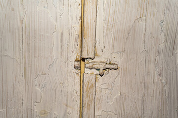 Old vintage white sideboard doors covered in cracked and worn paint