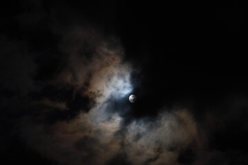 Moon in the night at cloudy sky