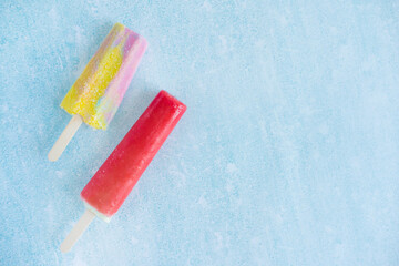 Two ice creams on a stick with place for text. Yummy ice-cream. Children's sweets, ice cream in summer