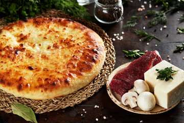 National Caucasian dish - Ossetian pies with cheese, potatoes, herbs, cottage cheese, beef, mushrooms