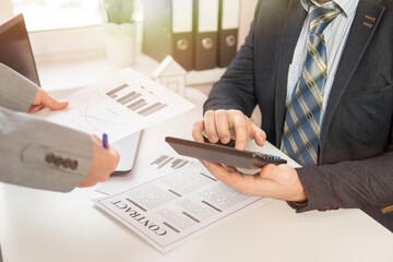 two businessmans at the table sign a contract. close-up. high quality