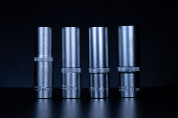 professional set of tool steel sockets with added vanadium and chrome on a dark background.