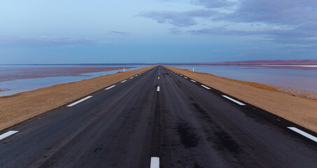 Desert landscape is early morning on the Tozeur highway crossing salt lake of Chott el Djerid, Tunisia