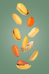 Isolated nuts. Nine mix peanuts with and witout shell in the air isolate on green with clipping path as package design element. Full depth of field. Food levitation concept.