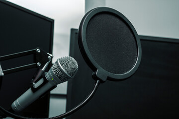 Close up on a microphone protected by a pop filter