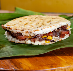 Colombian arepa stuffed with assorted meat and cheese