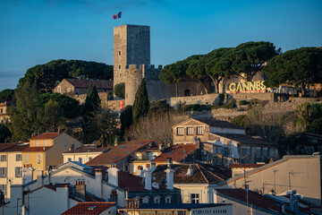 French flag on the old town of Cannes at sunset