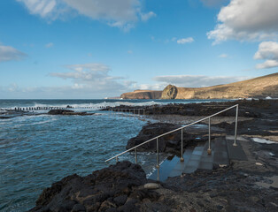 view of Natural sea pool Las Salinas de Agaete in Puerto de Las Nieves and coast cliffs. Gran...