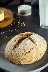 Close up green buckwheat bread and organic buckwheat milk. gray homemade Ceramic plate, linen napkin. Harmless,wellness, gluten free healthy baking for vegans. Alternative bread and vegeterian milk.