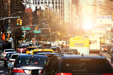 Traffic jam with cars crowding 1st Avenue during rush hour in New York City with sunlight in the background