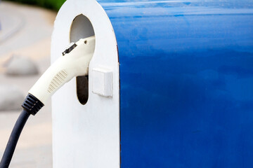  Electric Car Charging Column. Electric vehicle charging station for home with EV car background....
