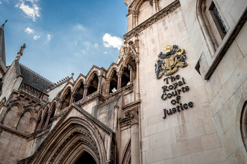 Law and order, judicial branch of government and Victorian architecture concept with arched doorway leading to the Great Hall of the Royal Courts Justice - 417477963
