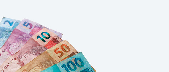 Brazilian Real banknotes isolated on white background. Brazilian money. Economy concept. Wide photo.
