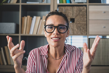 Head shot portrait confident businesswoman coach wearing glasses looking at camera and talking,...