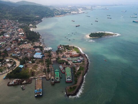 Aerial View Of Pelabuhan Merak Is A Marine Port And Town Harbor Island Of Merak In The Sunlight Morning. Ferry Boats, With Noise Cloud And Cityscape. 