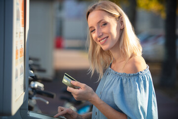 young cool woman with credit card renting a bike