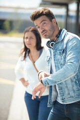 frustrated couple waiting departure with luggage