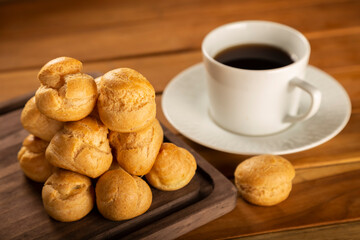 Delicious profiteroles on the table. Profiteroles dessert. Image with selective focus.
