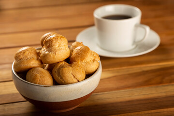 Delicious profiteroles on the table. Profiteroles dessert. Image with selective focus.