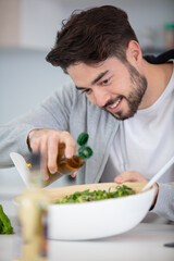 Fototapeta na wymiar young man eating a healthy salad