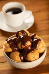 Profiteroles covered with chocolate sauce.