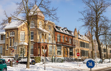 Art nouveau architecture of colorful mansion homes in winter with snow on the streets and on the...