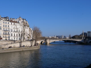 Fototapeta na wymiar The Seine river in Paris center in march 2021 during a sunny day.