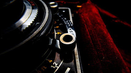 Close-up view of an old two-lens reflex camera, detail of a control.