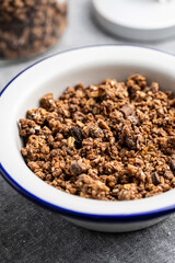 Chocolate breakfast cereal. Morning granola in bowl.