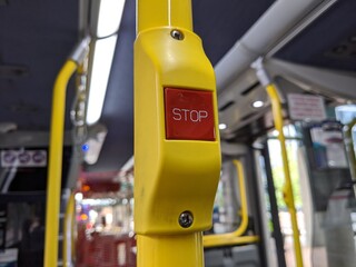 a red 'Stop' button inside a metro bus in Seattle