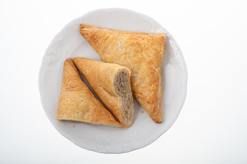 Crispy chicken patties triangle shape on white plate