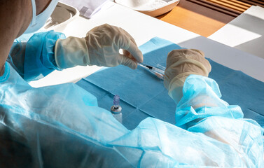A medical worker prepare an injection of vaccine during a massive vaccination day at a healthcare...