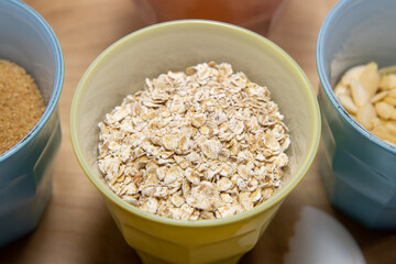 A cup of oats on a kitchen table ready to be used in baking