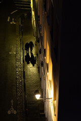 un couple marche dans une sombre ruelle de nuit, pentes de La Croix-Rousse,  Lyon, France 