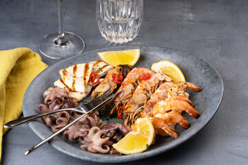 Seafood assorted platter - Prawn Shrimp, Squid, Octopus mini, lemon . High quality photo