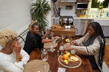 Black women creating DIY cocktails, friendship connections