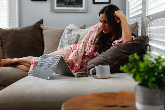 Professional Indian Woman Works Remotely From Home In Comfortable House Clothes