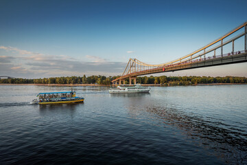 Boats on Dnieper River and Parkovy pedestrian bridge - Kiev, Ukraine