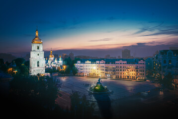 Fototapeta na wymiar Aerial view of Sofiyivska Square and St Sophia Cathedral illuminated at night - Kiev, Ukraine