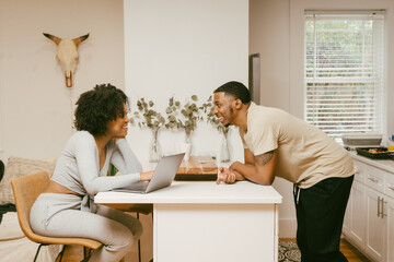 Cozy and comfy Black couple having conversation in kitchen