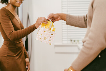 Couple celebrating anniversary at home, exchange gifts