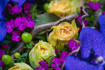 detail of a bouquet of yellow roses and orchid
