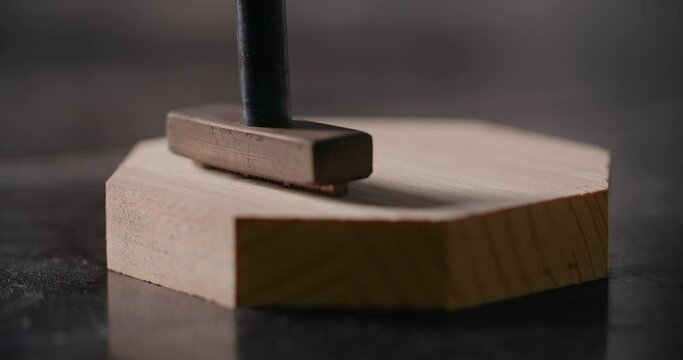 Close up video: hot stamp is placed with red-hot tool to the wooden product with smoke in slow motion, marking the final product, 4k 60p Prores 422 HQ 10 bit