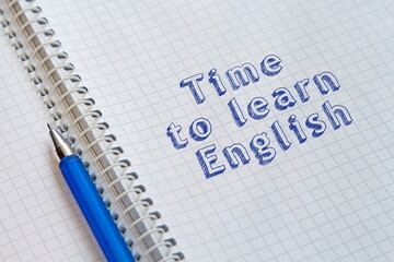 Time to learn English. Text in an open notebook. Concept of education, starting school, back to school