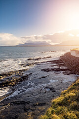 View on the Atlantic ocean. Mullaghmore peninsula, county Sligo, Ireland. Blue water with waves, cloudy sky, nobody. Mountains in the background. Vertical image