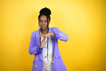 Young african american business woman Doing time out gesture with hands, frustrated and serious face