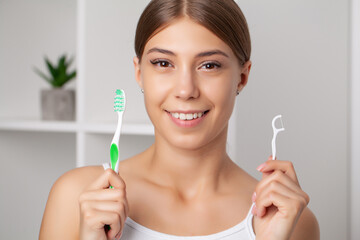 Oral hygiene and health care, smiling women use dental floss white healthy teeth.