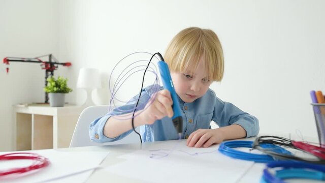 Little boy learning make model with 3d printing pen. Child playing with new modern toy for creativity. DIY. 