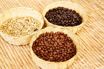 Mexico, Sierra Madre Mountains. Baskets of plantation coffee beans in stages of roasting.